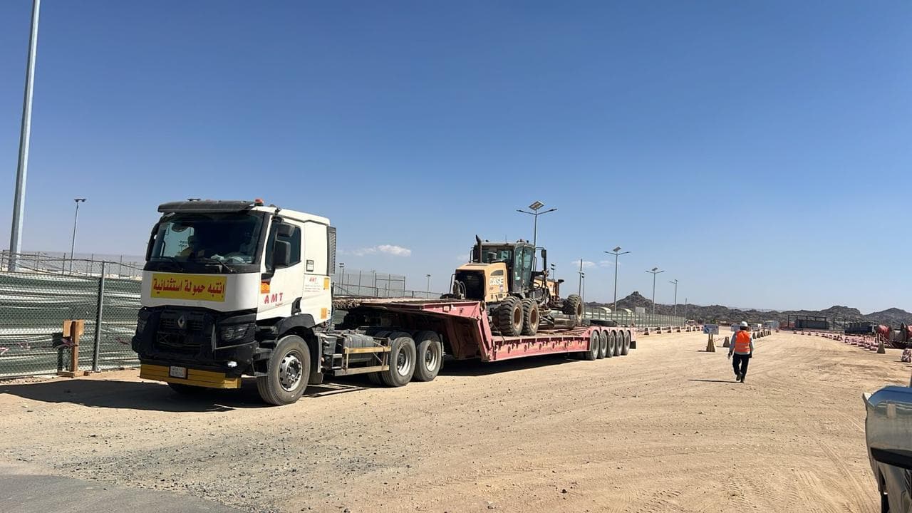 5-axle hydraulic lowbed loaded with road equipment