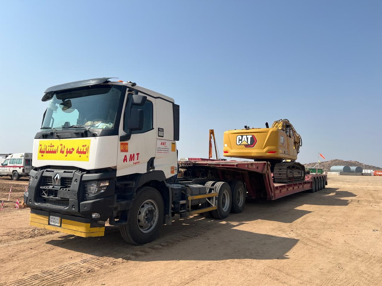 5-axle hydraulic lowbed loaded with heavy equipment