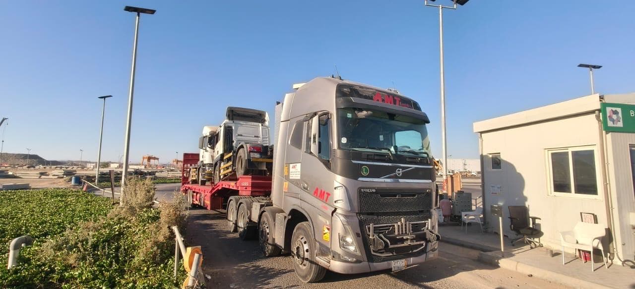 2-axle lowbed loaded with trucks